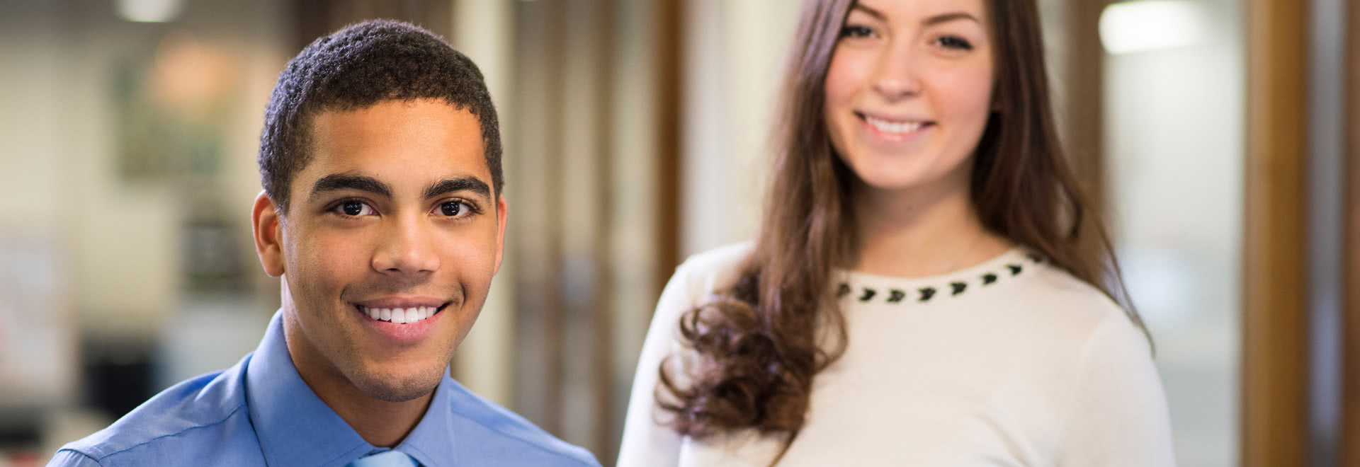 Two young interns smiling