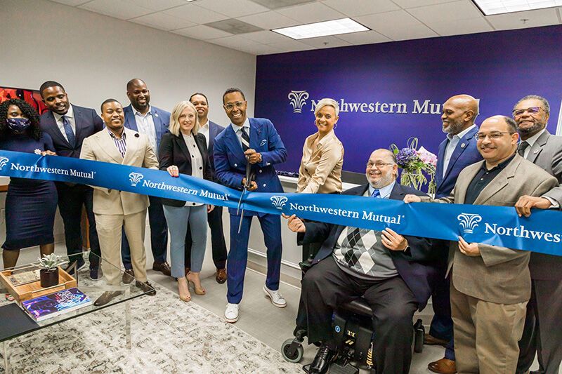Leo Tucker, and the Bowie office team cutting their ceremonial grand opening ribbon.