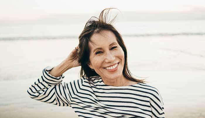 a smiling woman at the beach